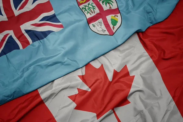 Waving colorful flag of canada and national flag of Fiji . — Stock Photo, Image