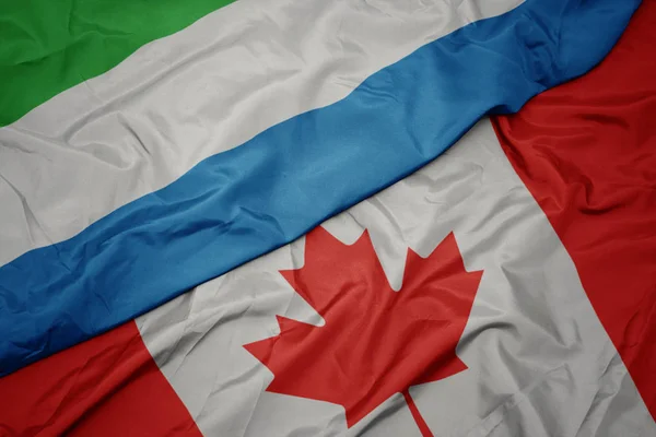 Ondeando colorida bandera de Canadá y bandera nacional de Sierra Leona . —  Fotos de Stock