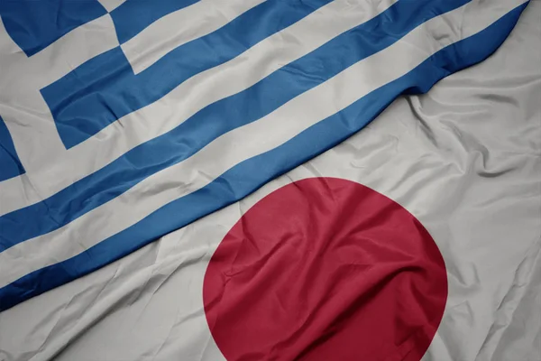 waving colorful flag of japan and national flag of greece.