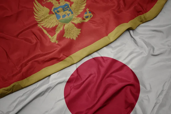 waving colorful flag of japan and national flag of montenegro.