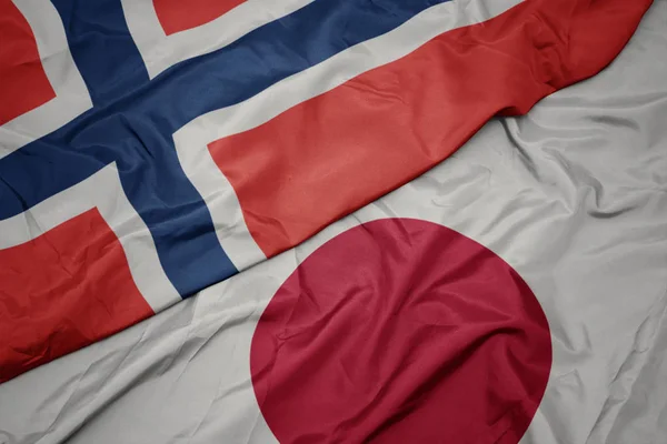 waving colorful flag of japan and national flag of norway.