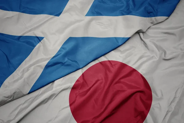 Waving colorful flag of japan and national flag of scotland. — Stock Photo, Image