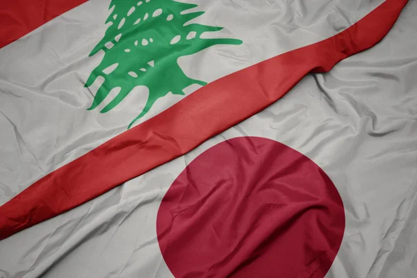 Waving colorful flag of japan and national flag of lebanon. — Stock Photo, Image