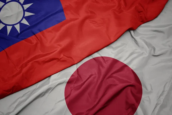 waving colorful flag of japan and national flag of taiwan.