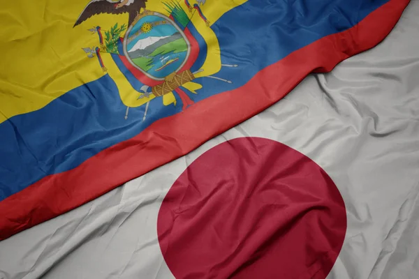 waving colorful flag of japan and national flag of ecuador.