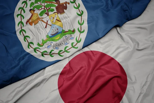 Waving colorful flag of japan and national flag of belize. — Stock Photo, Image