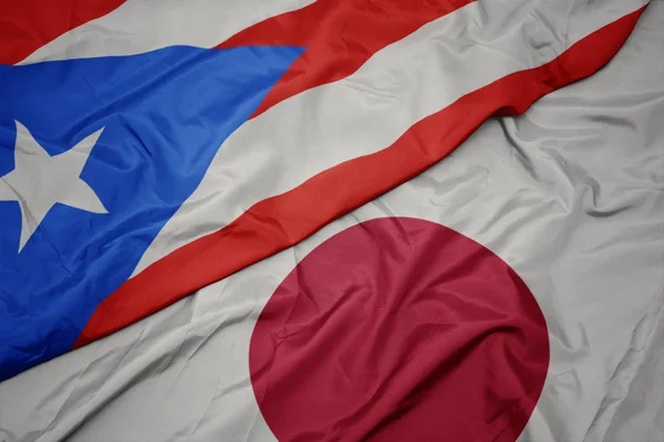 waving colorful flag of japan and national flag of puerto rico.