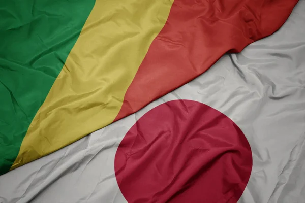 Acenando bandeira colorida do japão e bandeira nacional da república do Congo . — Fotografia de Stock