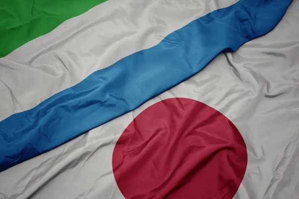 Waving colorful flag of japan and national flag of sierra leone. — Stock Photo, Image