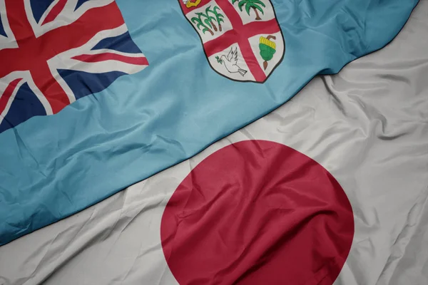 Waving colorful flag of japan and national flag of Fiji. — Stock Photo, Image