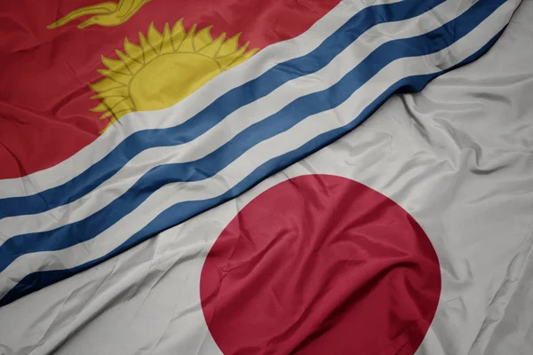 waving colorful flag of japan and national flag of Kiribati.
