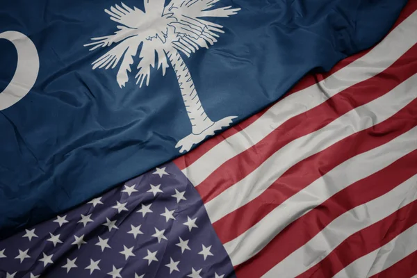 Waving colorful flag of united states of america and flag of south carolina state. — Stock Photo, Image