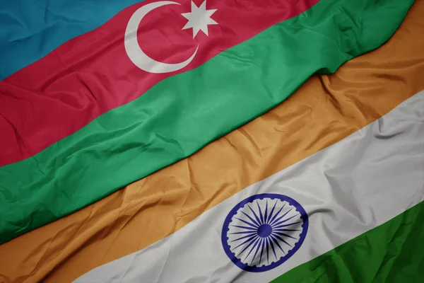 waving colorful flag of india and national flag of azerbaijan.