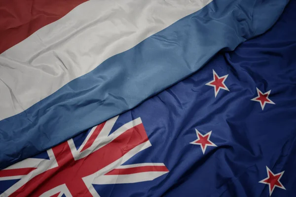 Waving colorful flag of new zealand and national flag of luxembourg. — Stock Photo, Image