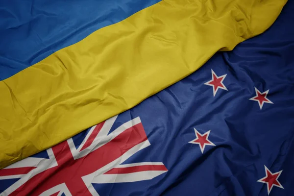 Waving colorful flag of new zealand and national flag of ukraine. — Stock Photo, Image