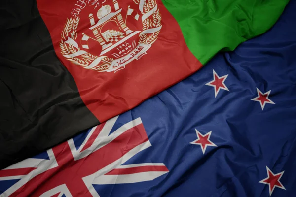 Waving colorful flag of new zealand and national flag of afghanistan. — Stock Photo, Image