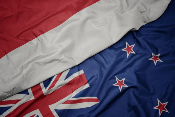 Waving colorful flag of new zealand and national flag of indonesia. — Stock Photo, Image