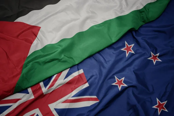 Waving colorful flag of new zealand and national flag of palestine. — Stock Photo, Image