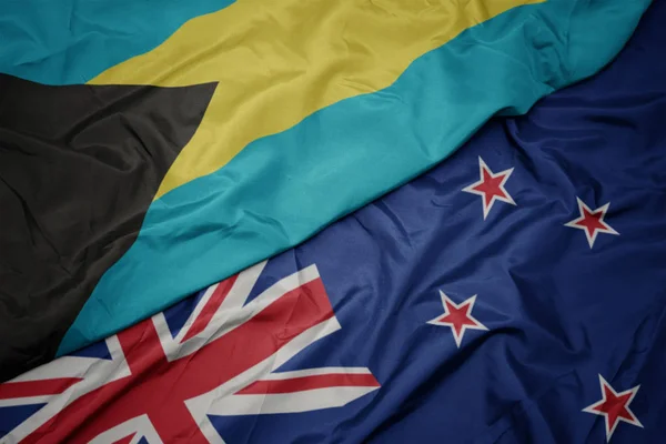 Waving colorful flag of new zealand and national flag of bahamas. — Stock Photo, Image