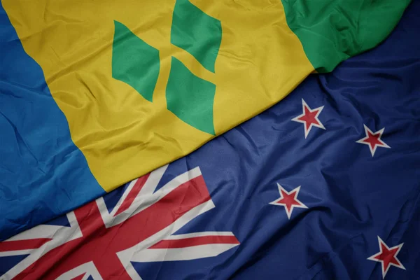 Waving colorful flag of new zealand and national flag of saint vincent and the grenadines. — Stock Photo, Image