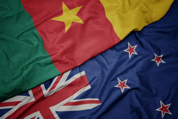 Waving colorful flag of new zealand and national flag of cameroon. — Stock Photo, Image