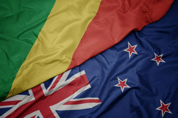 Waving colorful flag of new zealand and national flag of republic of the congo. — Stock Photo, Image