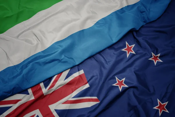 Waving colorful flag of new zealand and national flag of sierra leone. — Stock Photo, Image