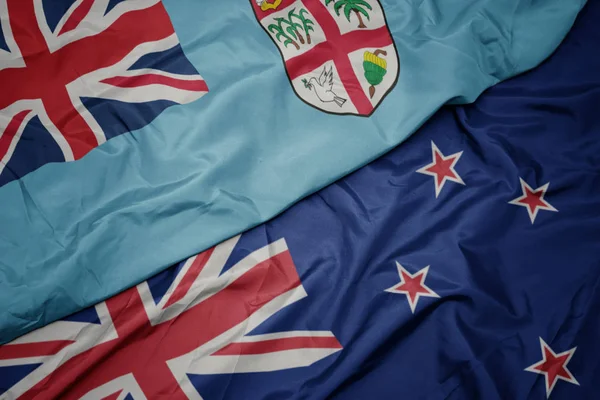 Waving colorful flag of new zealand and national flag of Fiji. — Stock Photo, Image