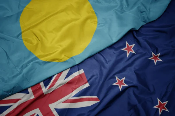 Waving colorful flag of new zealand and national flag of Palau. — Stock Photo, Image