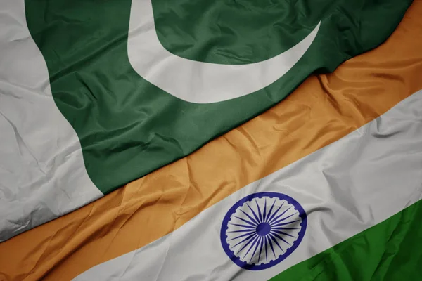 waving colorful flag of india and national flag of pakistan.