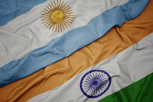 waving colorful flag of india and national flag of argentina.