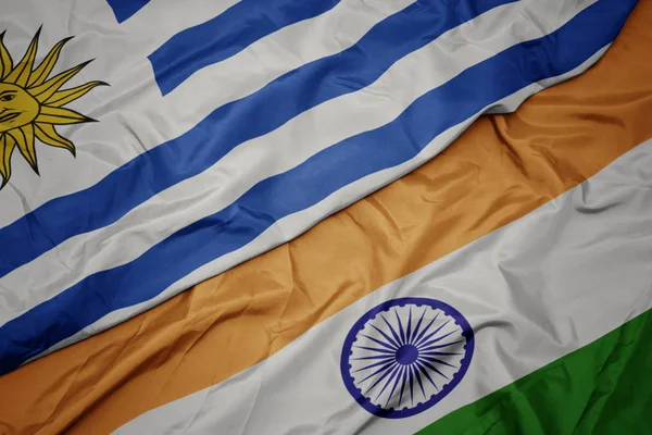 Waving colorful flag of india and national flag of uruguay. — Stock Photo, Image