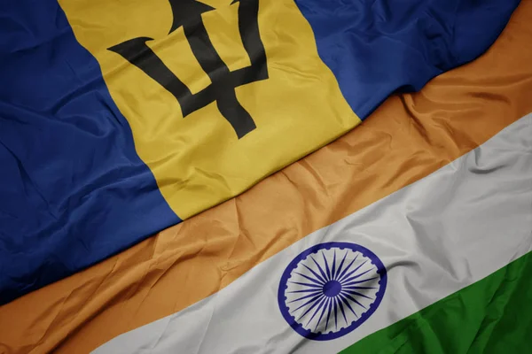 waving colorful flag of india and national flag of barbados.