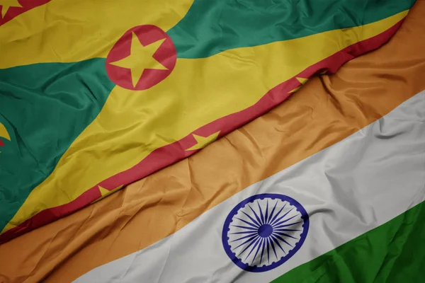 waving colorful flag of india and national flag of grenada.