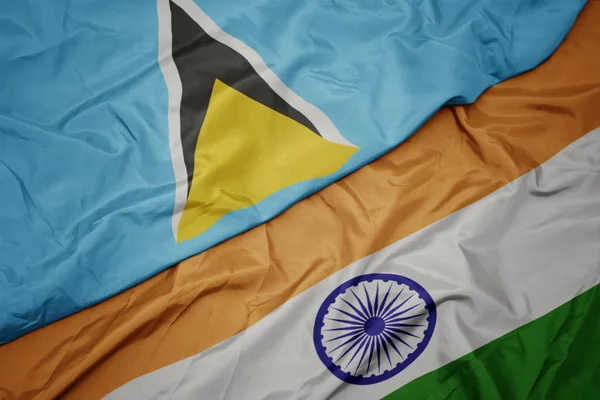 waving colorful flag of india and national flag of saint lucia.