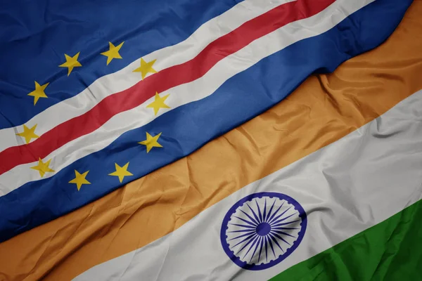 waving colorful flag of india and national flag of cape verde.