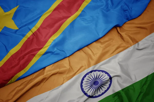 waving colorful flag of india and national flag of democratic republic of the congo.