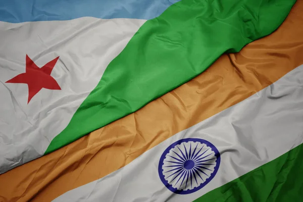 waving colorful flag of india and national flag of djibouti.