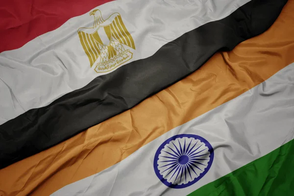 waving colorful flag of india and national flag of egypt.