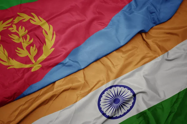 waving colorful flag of india and national flag of eritrea.