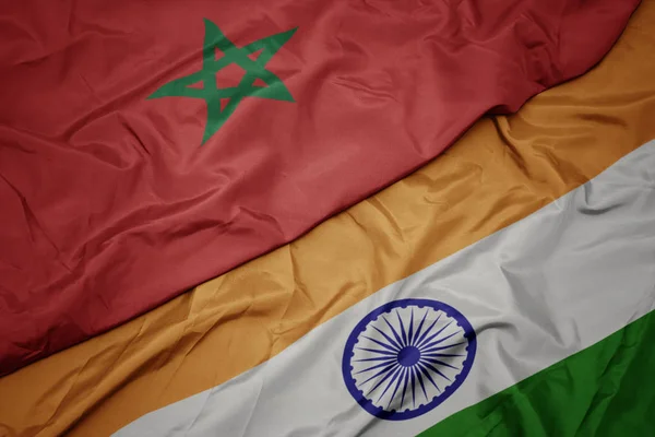 waving colorful flag of india and national flag of morocco.