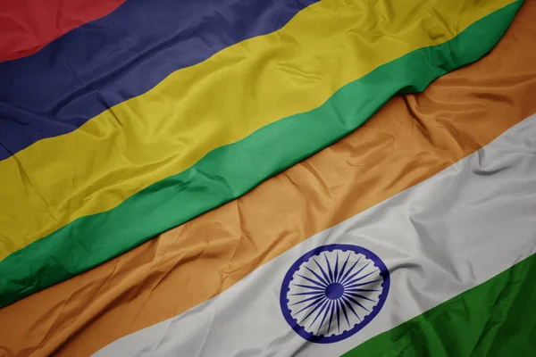 waving colorful flag of india and national flag of mauritius.
