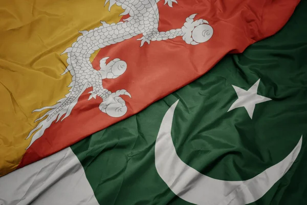 Waving colorful flag of pakistan and national flag of bhutan. — Stock Photo, Image