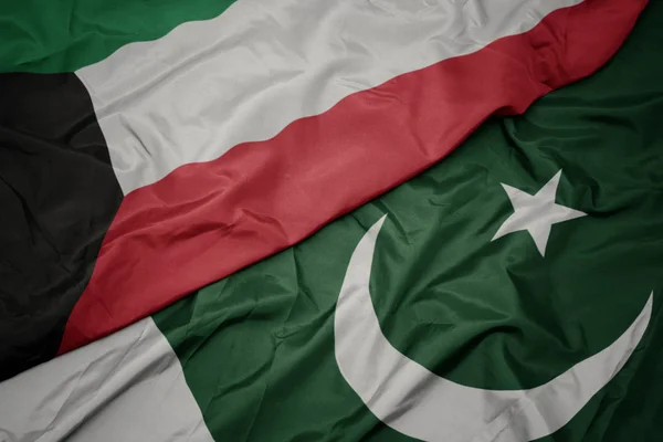 Waving colorful flag of pakistan and national flag of kuwait. — Stock Photo, Image