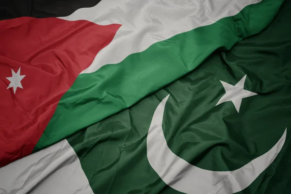 Waving colorful flag of pakistan and national flag of jordan. — Stock Photo, Image