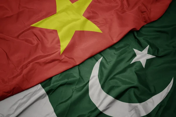 Waving colorful flag of pakistan and national flag of vietnam. — Stock Photo, Image
