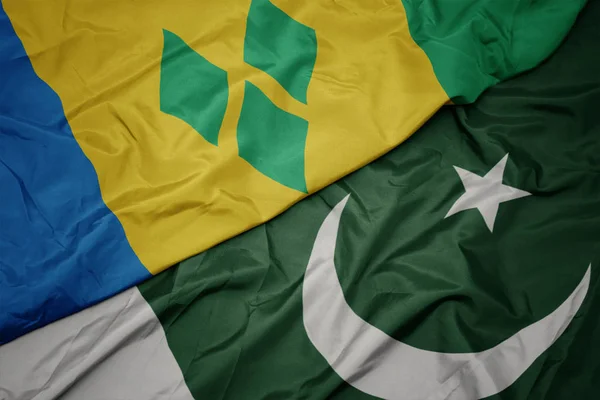 Waving colorful flag of pakistan and national flag of saint vincent and the grenadines. — Stock Photo, Image