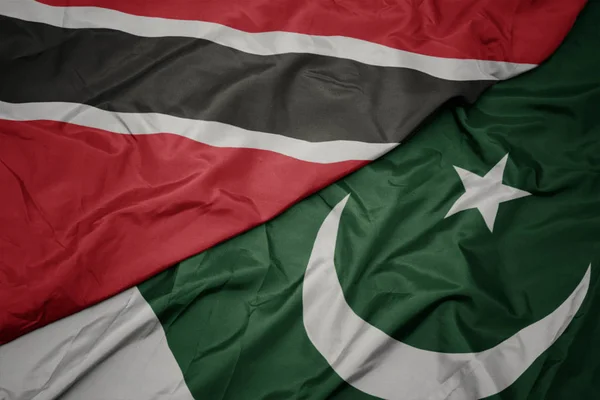 Waving colorful flag of pakistan and national flag of trinidad and tobago . — Stock Photo, Image