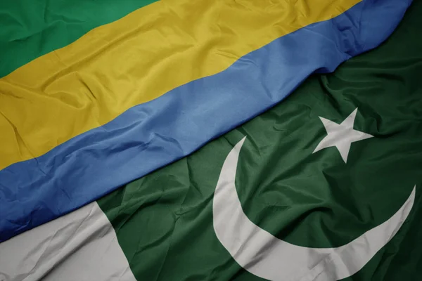 waving colorful flag of pakistan and national flag of gabon.
