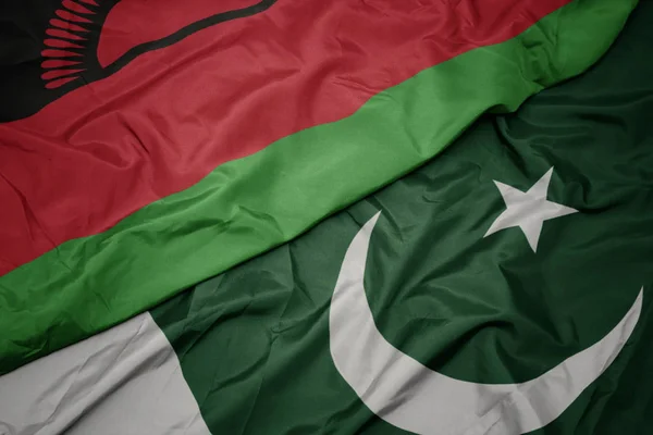 Waving colorful flag of pakistan and national flag of malawi. — Stock Photo, Image